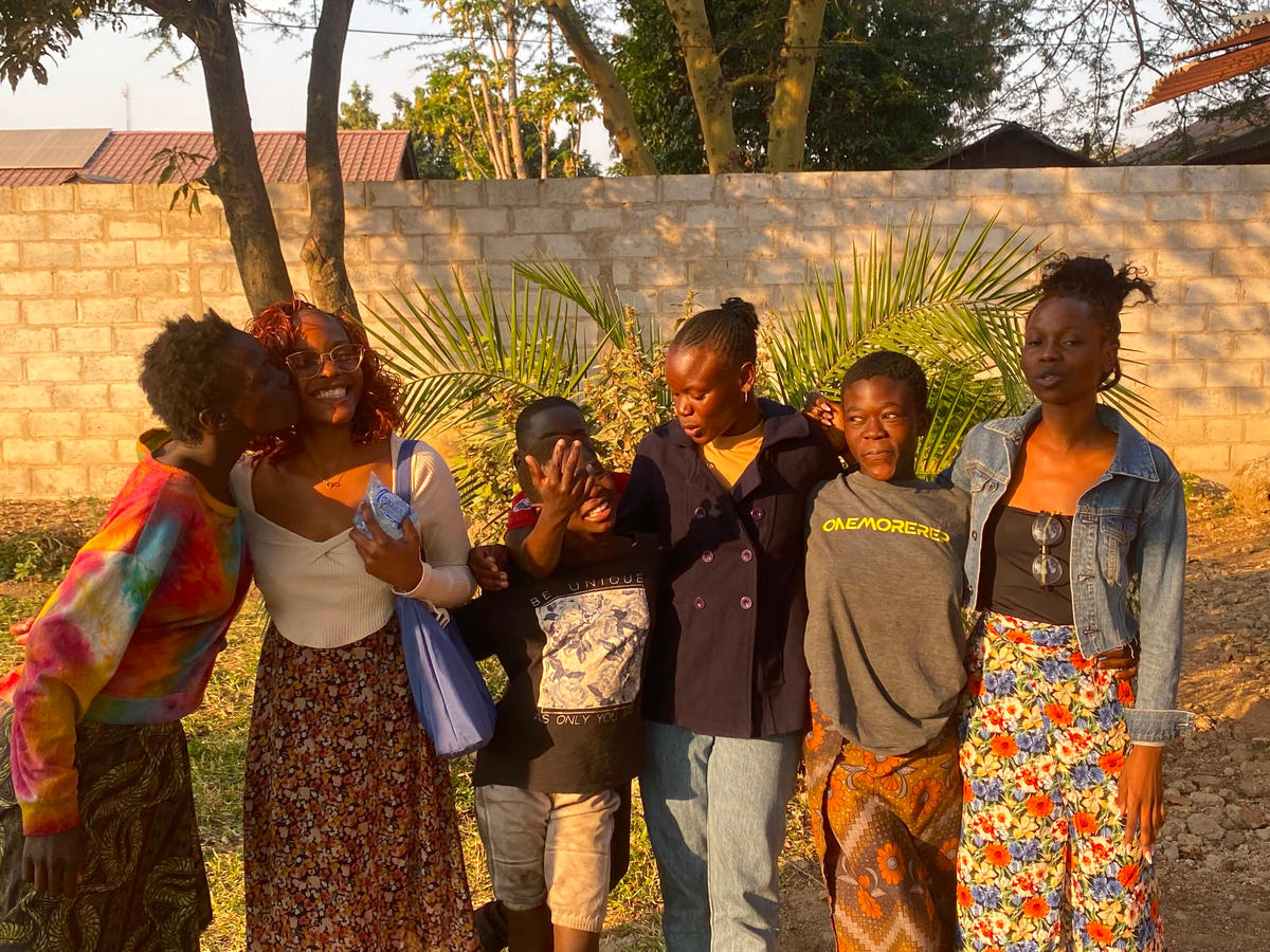 A group standing together outdoors in evening light