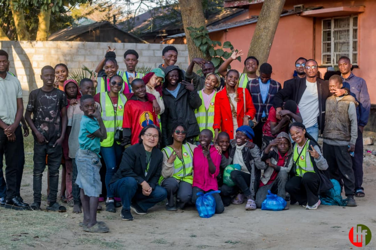 A wide group portrait of a ministry gathering outdoors