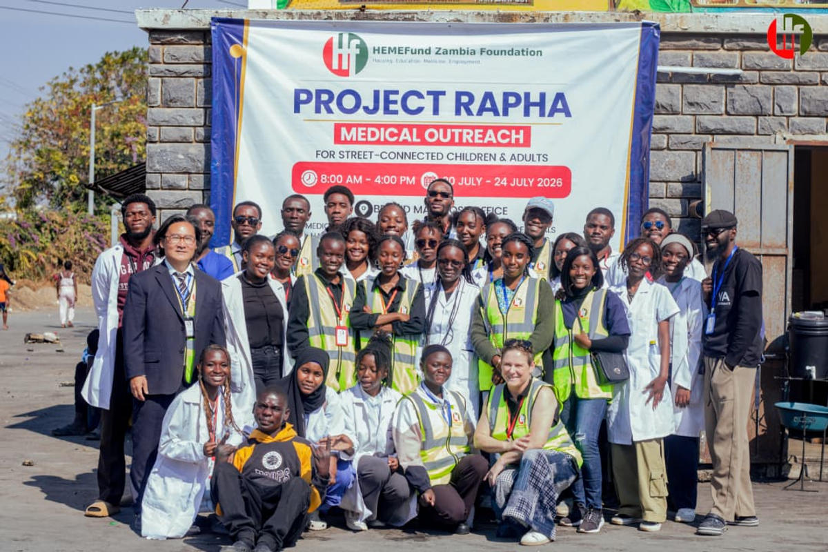 The Project Rapha team gathered in front of the medical outreach banner