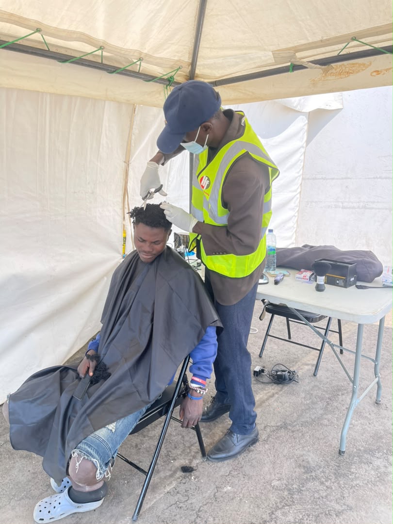 A volunteer giving a haircut