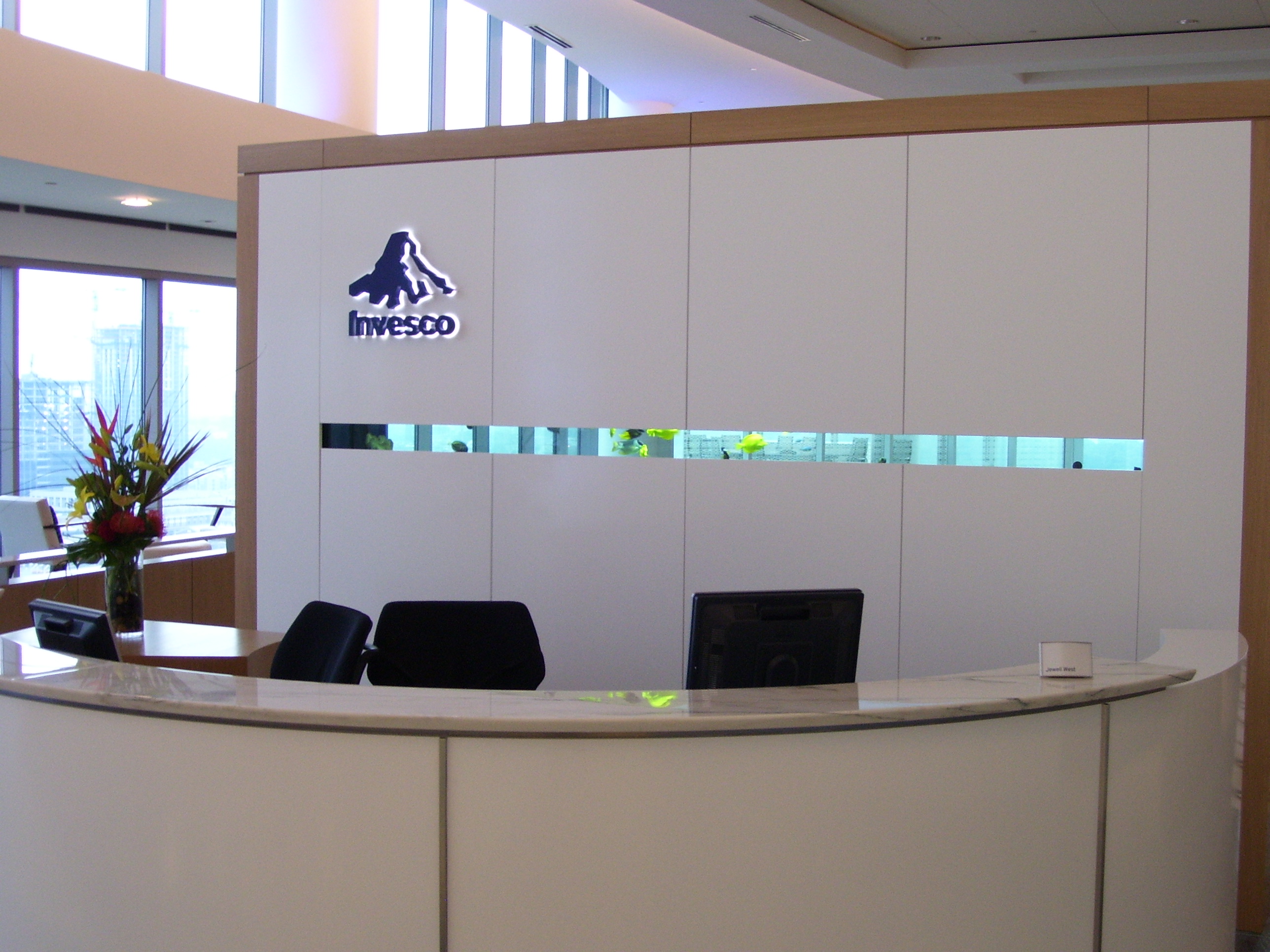 Invesco HQ integration proof, reception, executive corner offices with Atlanta skyline views, glass conference rooms, auditorium AV, video conferencing control room, codec farm server racks, and the executive workspace.