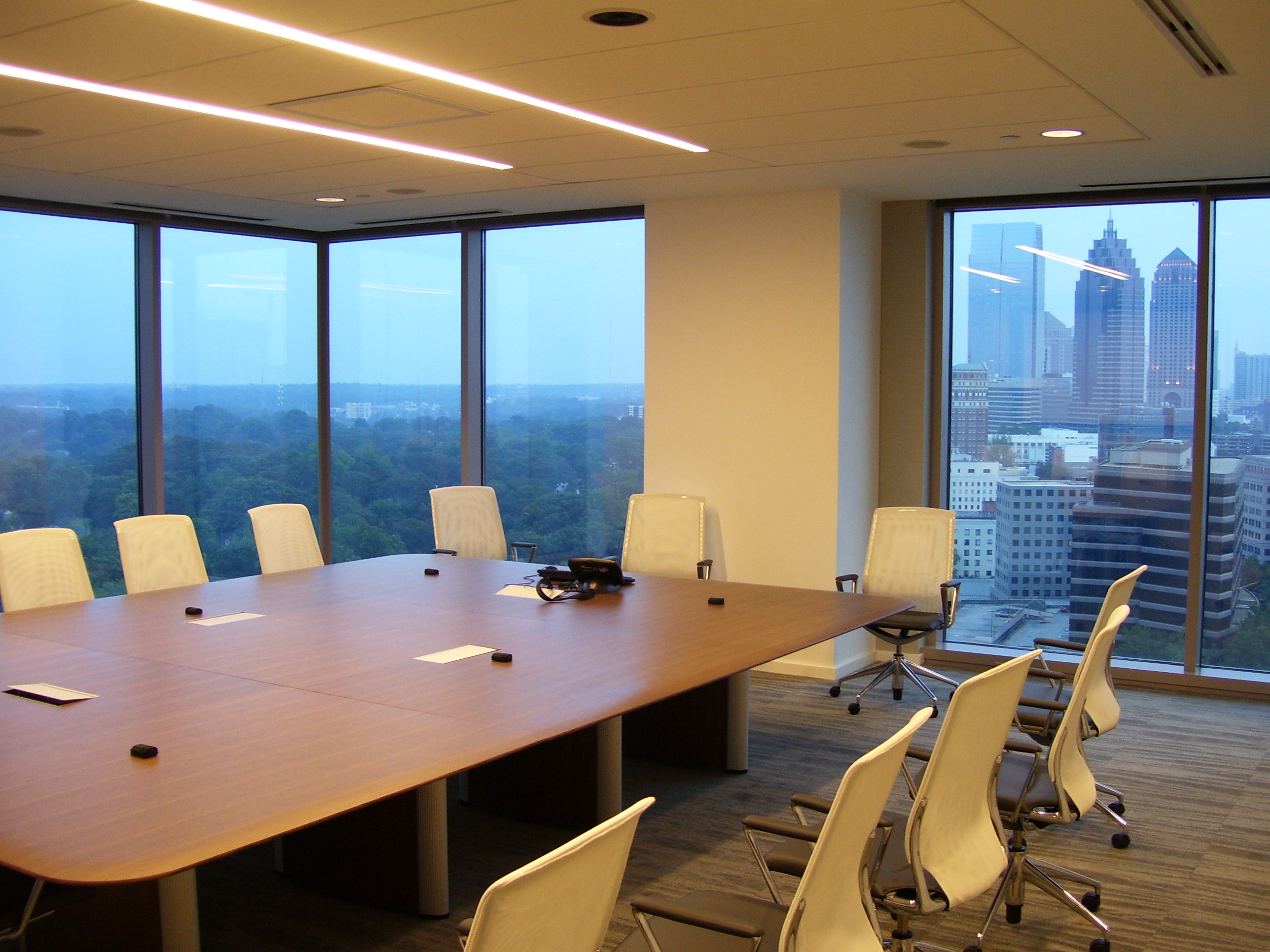 Invesco HQ integration proof, reception, executive corner offices with Atlanta skyline views, glass conference rooms, auditorium AV, video conferencing control room, codec farm server racks, and the executive workspace.