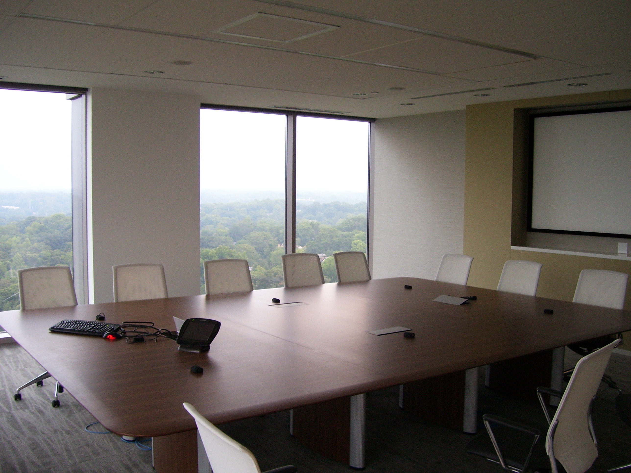 Invesco HQ integration proof, reception, executive corner offices with Atlanta skyline views, glass conference rooms, auditorium AV, video conferencing control room, codec farm server racks, and the executive workspace.