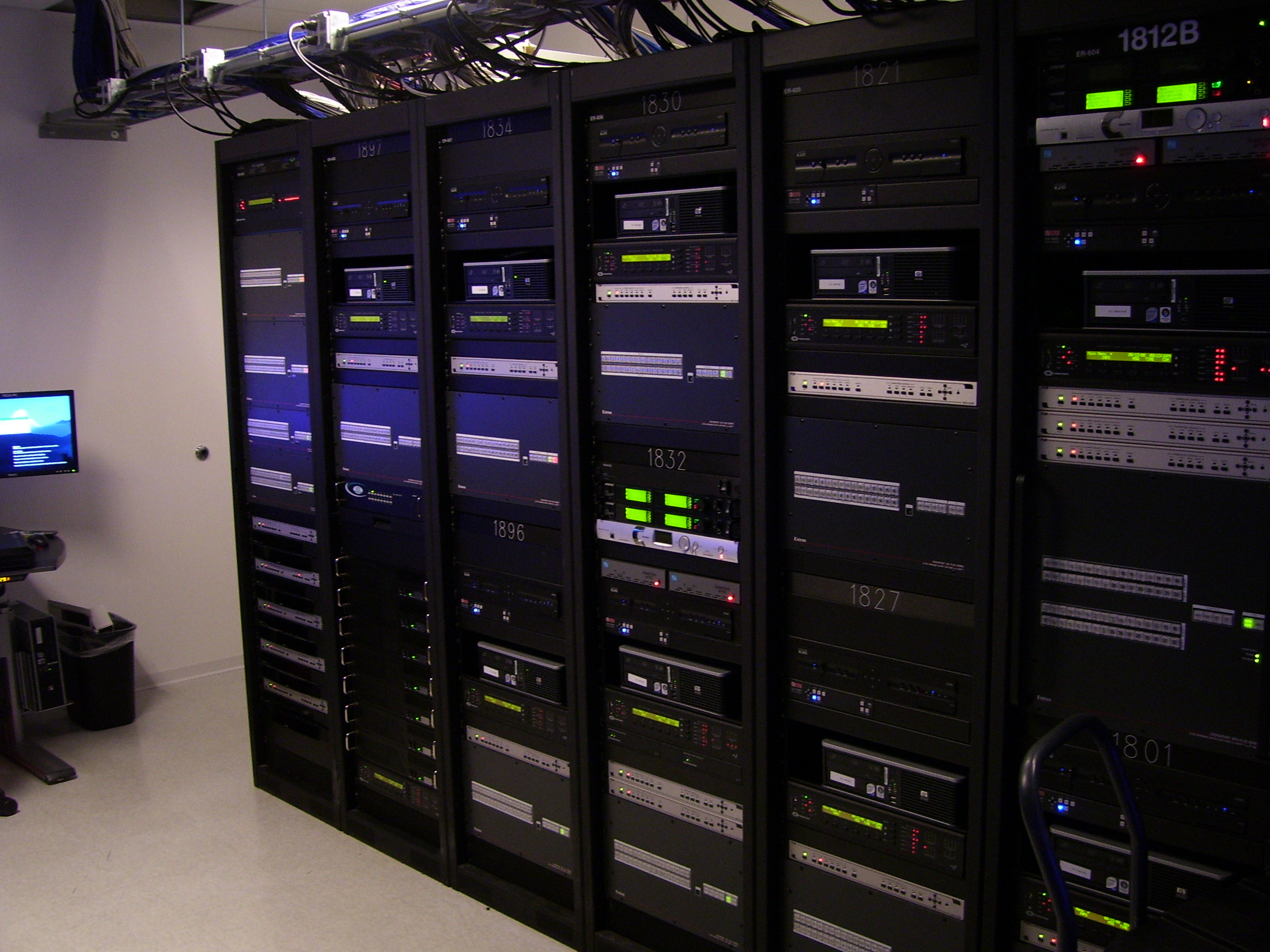 Invesco HQ integration proof, reception, executive corner offices with Atlanta skyline views, glass conference rooms, auditorium AV, video conferencing control room, codec farm server racks, and the executive workspace.