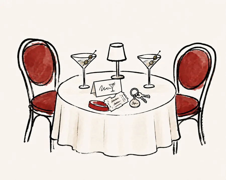 A set table for two with martini glasses, a lamp, menu and ticket