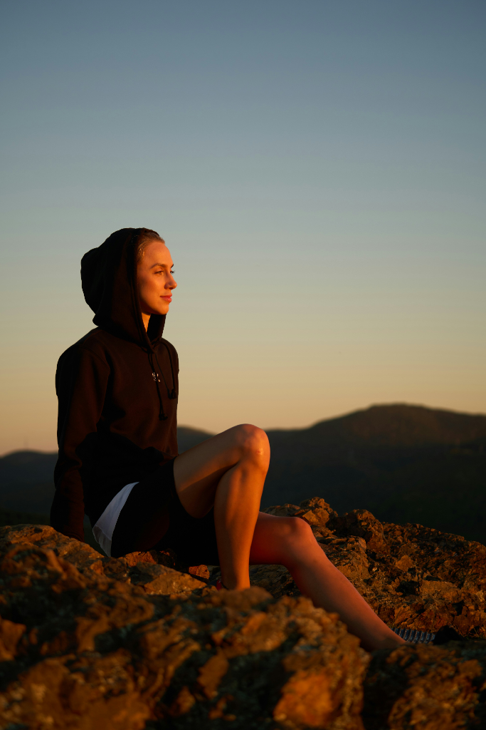 Female athlete at peace outdoors at sunset