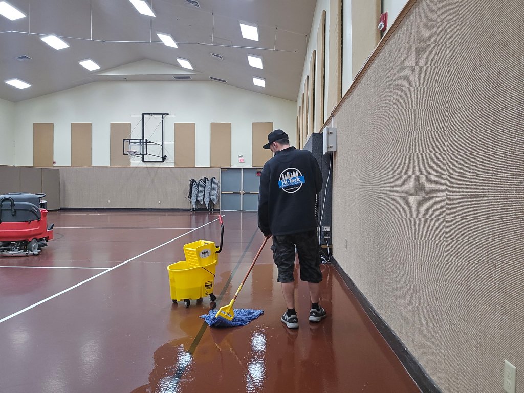 Hi-Teck technician mopping a basketball court