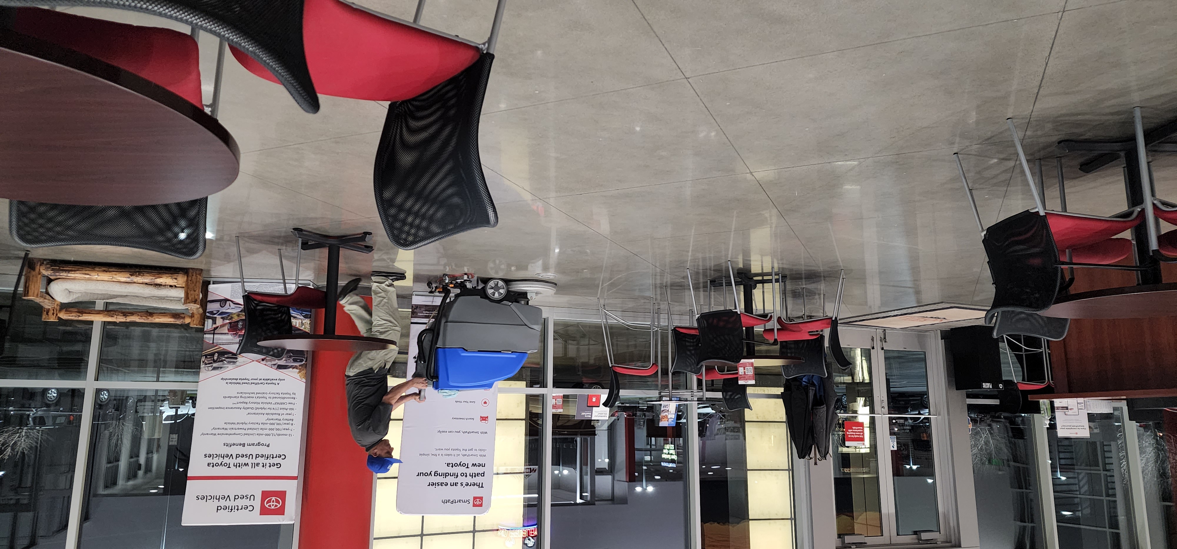 Hi-Teck floor scrubber cleaning a dealership showroom