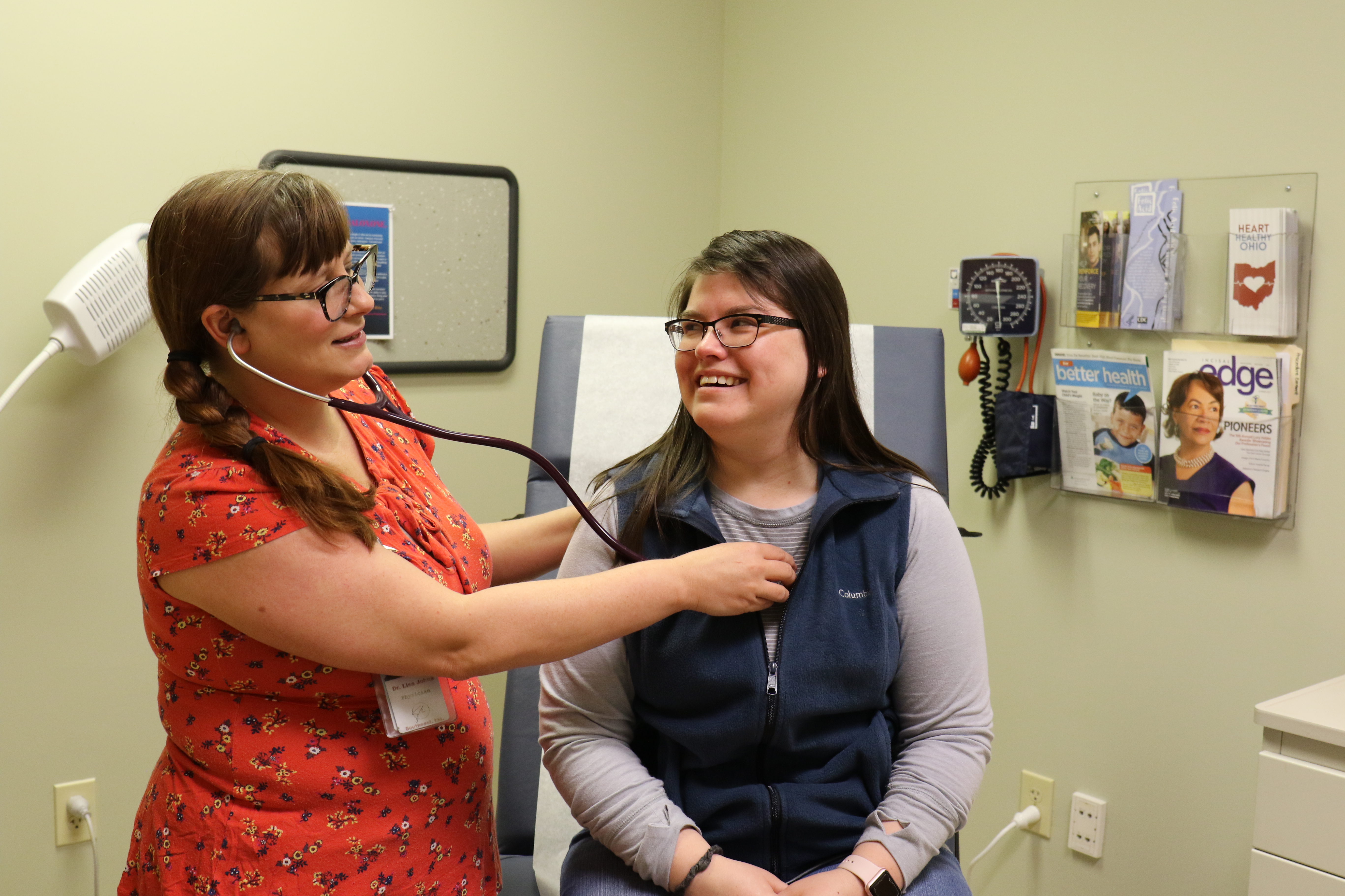 Clinician listening to a patient's heart with a stethoscope