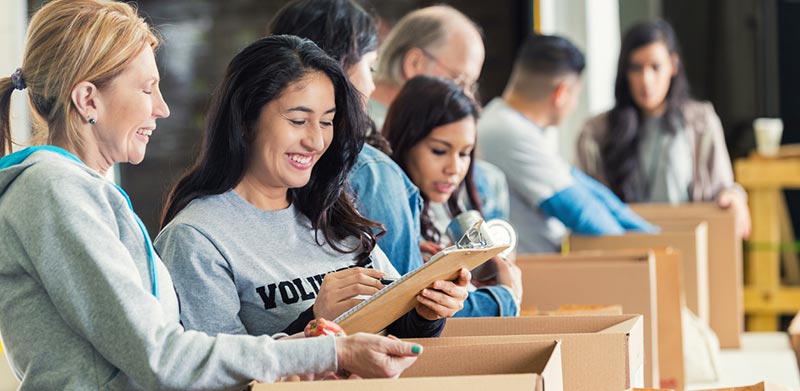 Young adults working at desks in a classroom training setting
