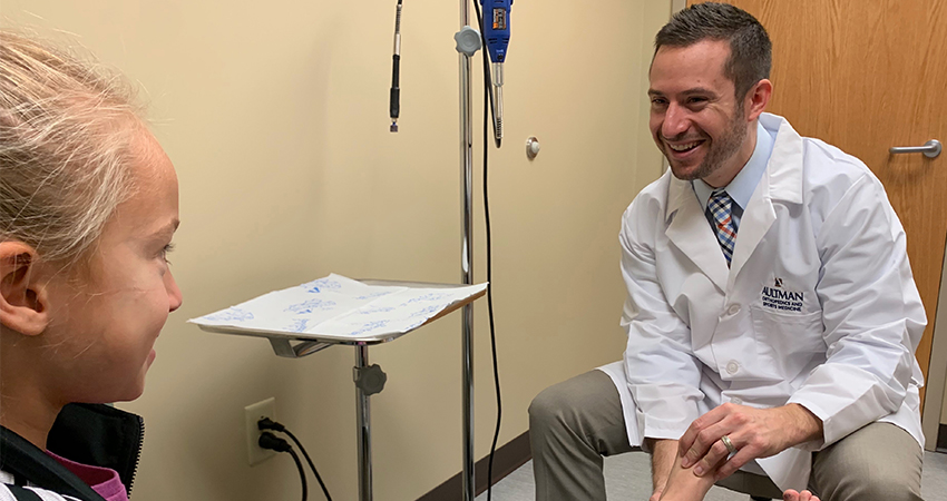 Doctor talking with a young girl patient
