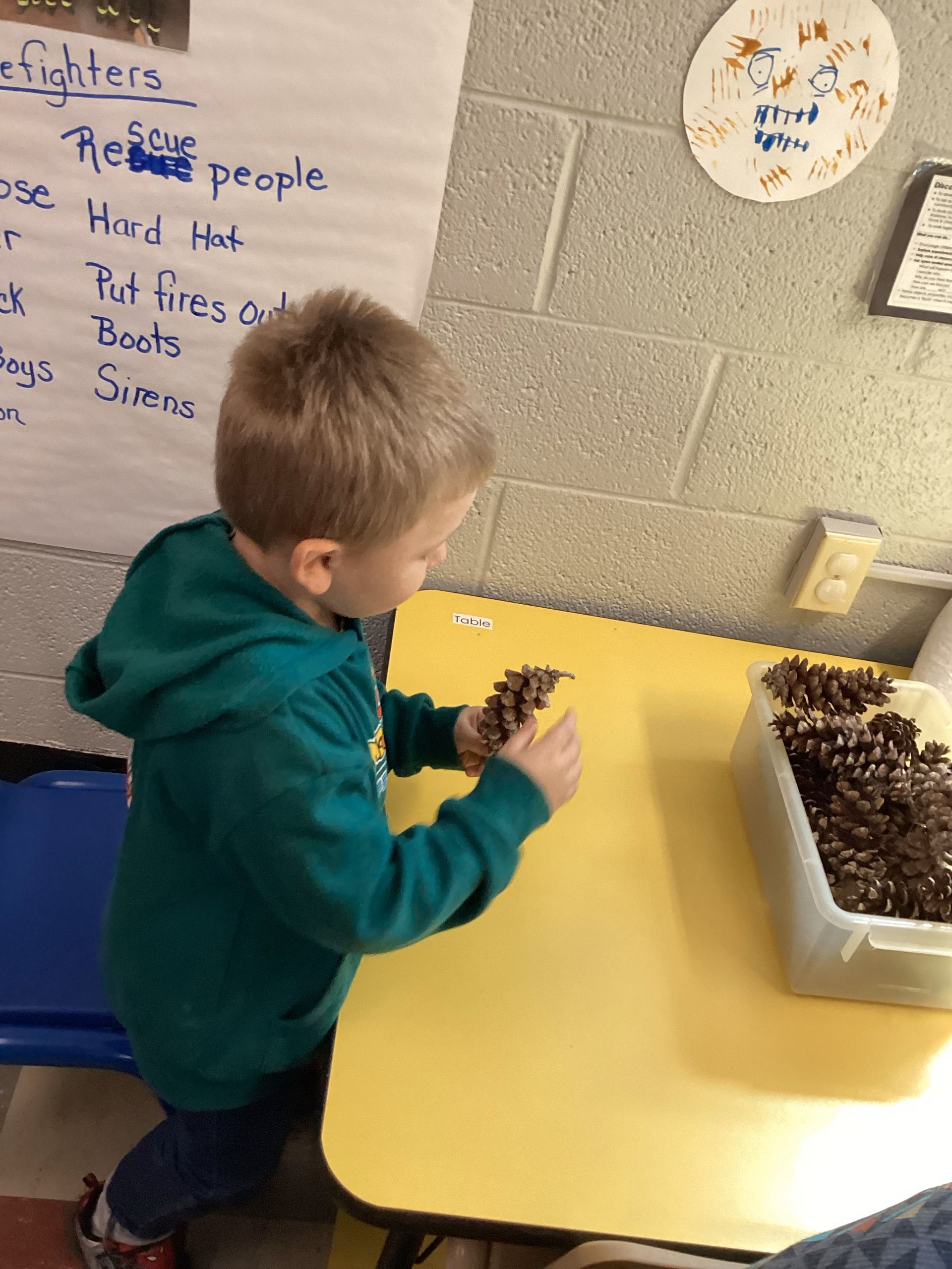 Young boy working at a table in a Head Start classroom