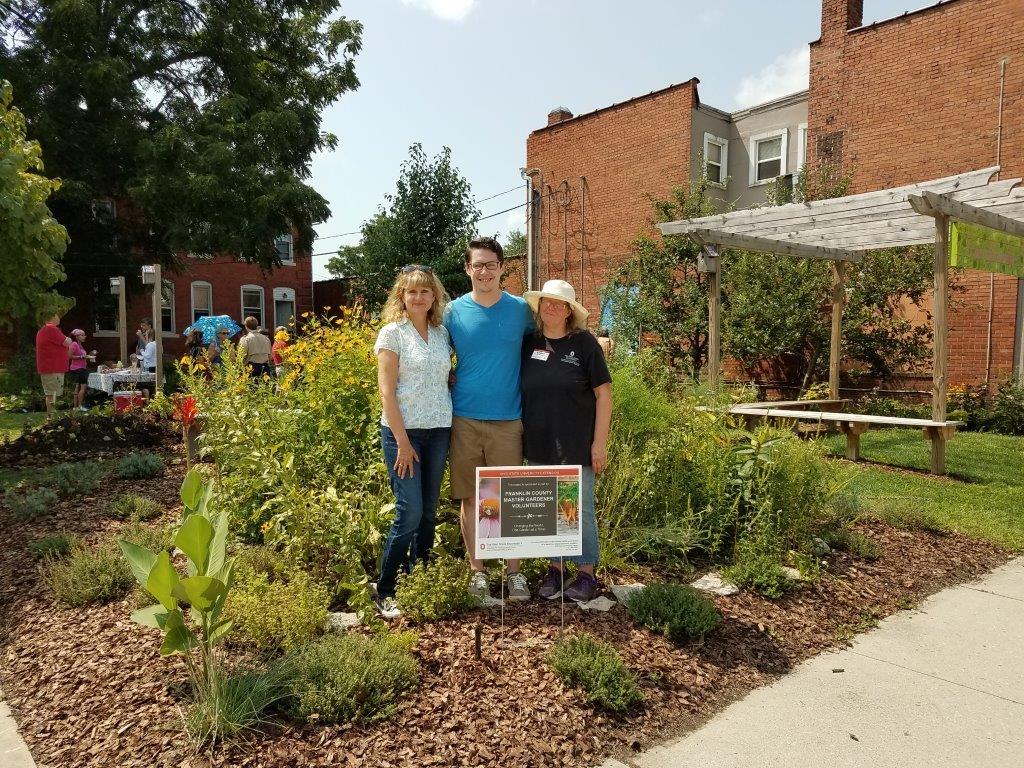Group of people standing together in a community garden