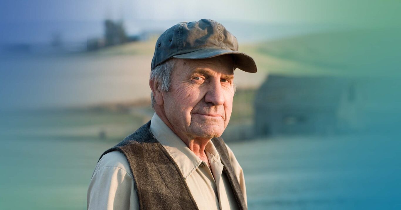 Older man in a cap and vest, outdoors portrait