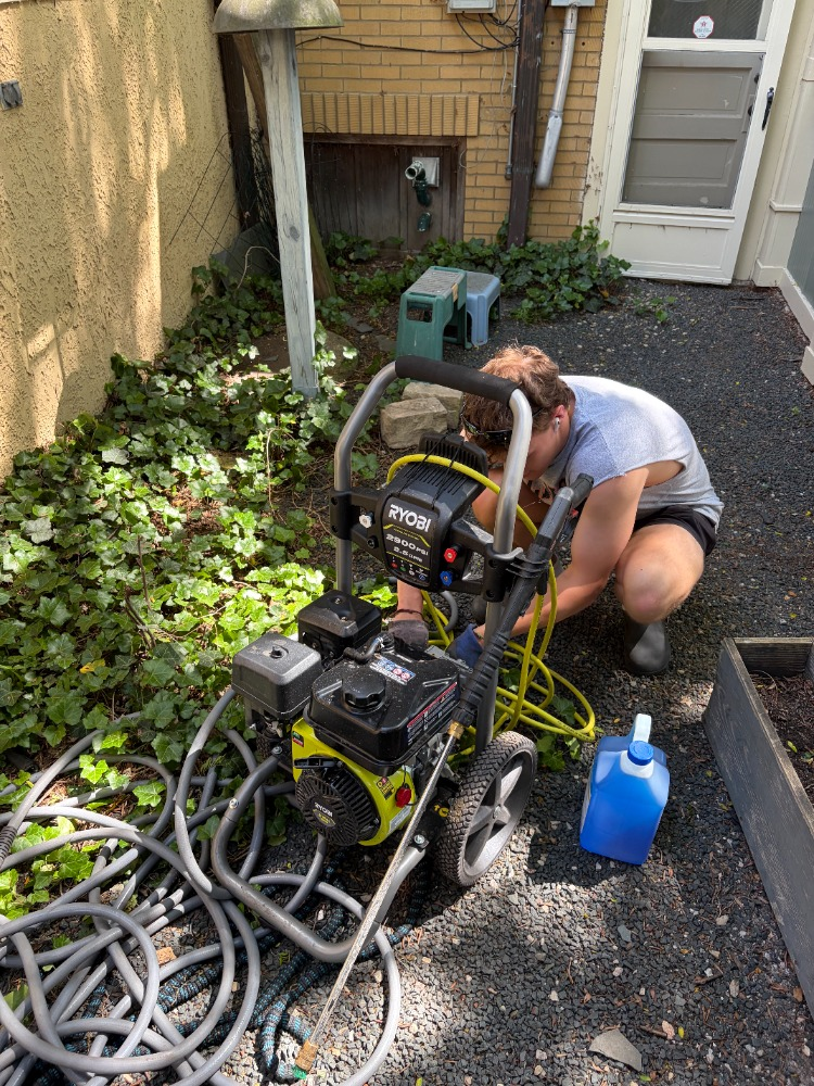 Teo setting up the Ryobi 2300 PSI pressure washer on a job