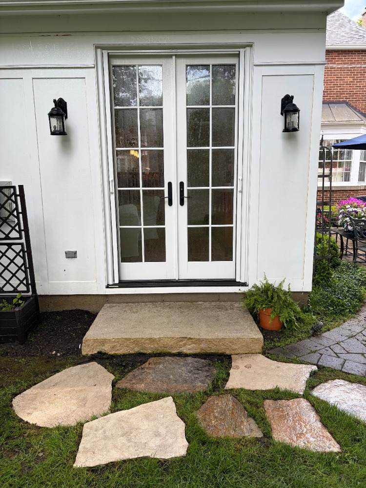 After pressure washing โ clean bright concrete step and restored stonework