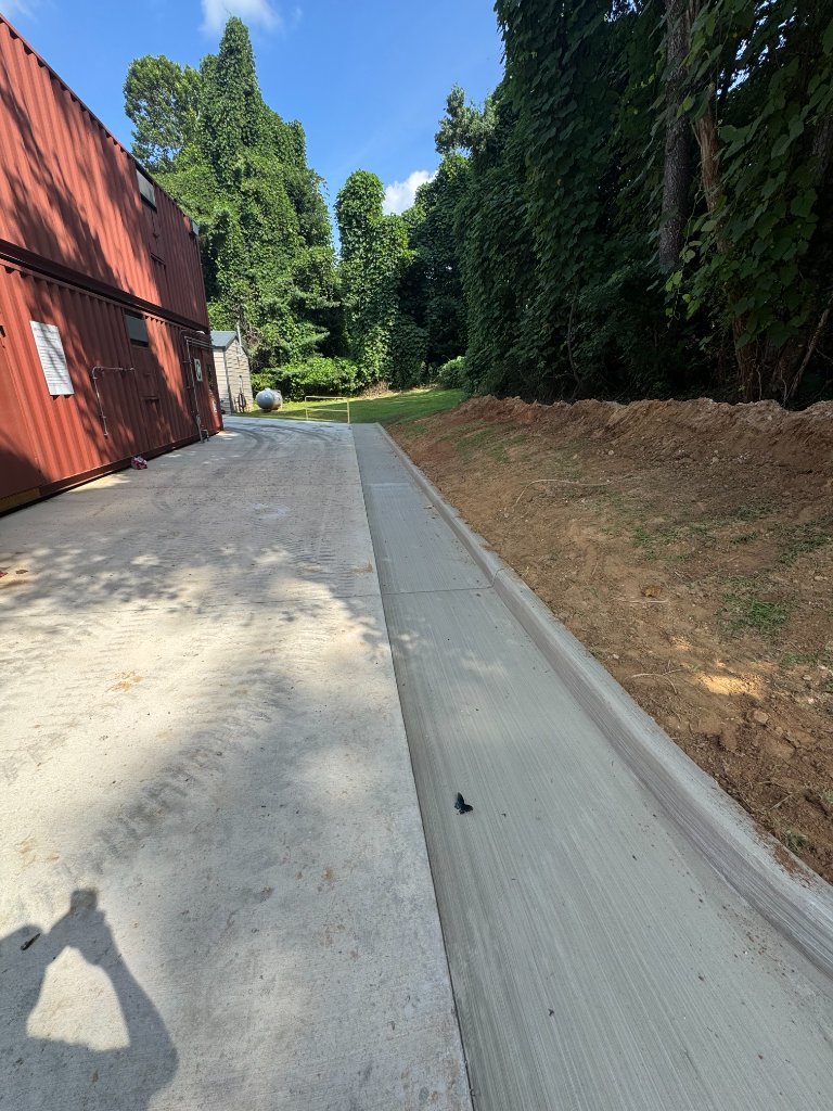 Concrete driveway alongside shipping container building