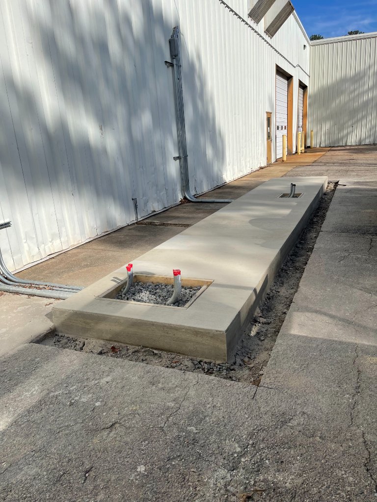 Commercial concrete utility pad with conduit