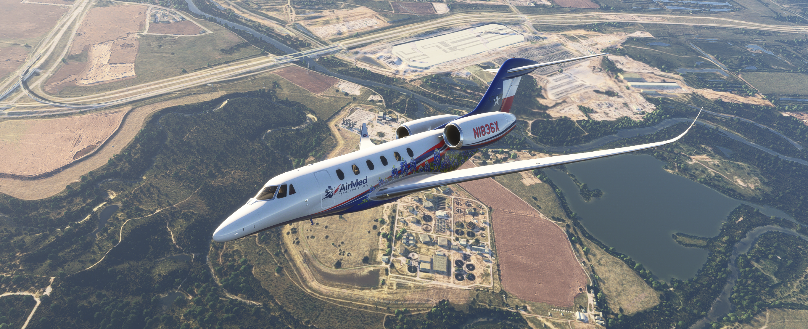 AirMed business jet (N1836X) in flight over a winding river