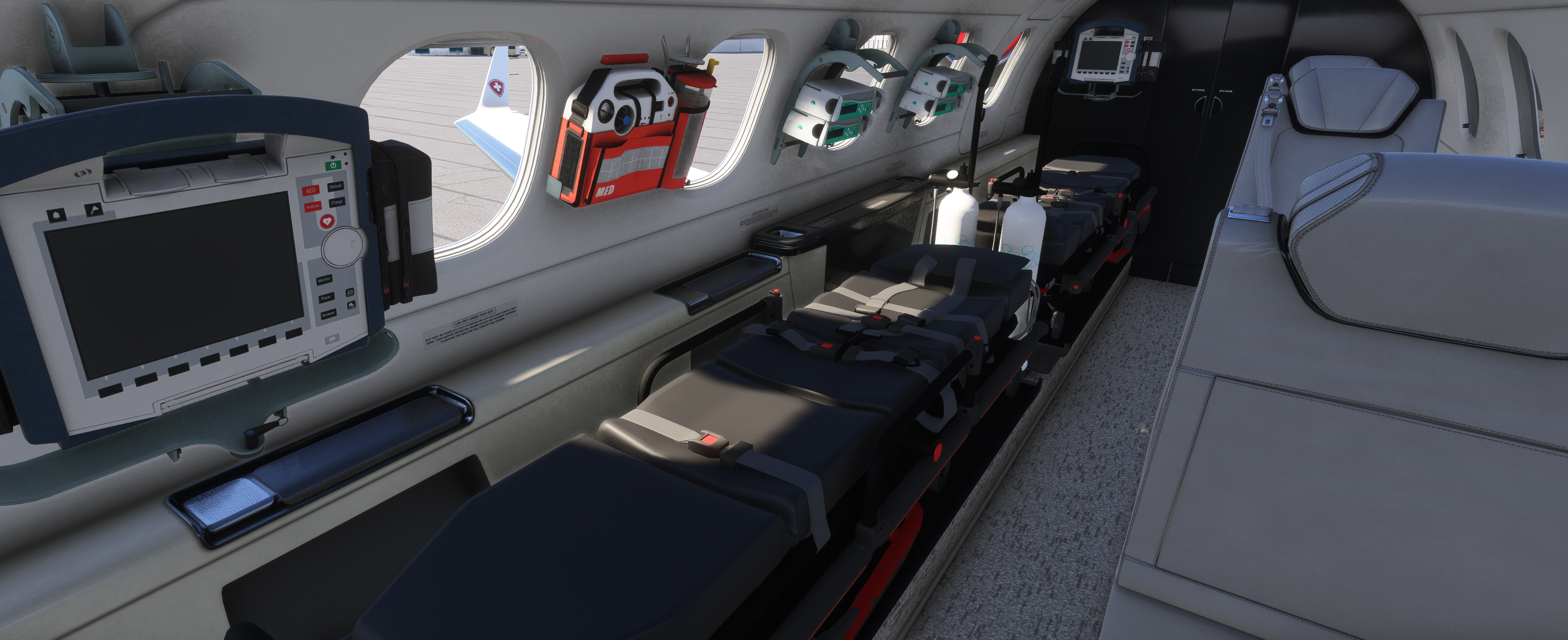 Interior view of an AirMed aircraft medical cabin with stretcher and equipment