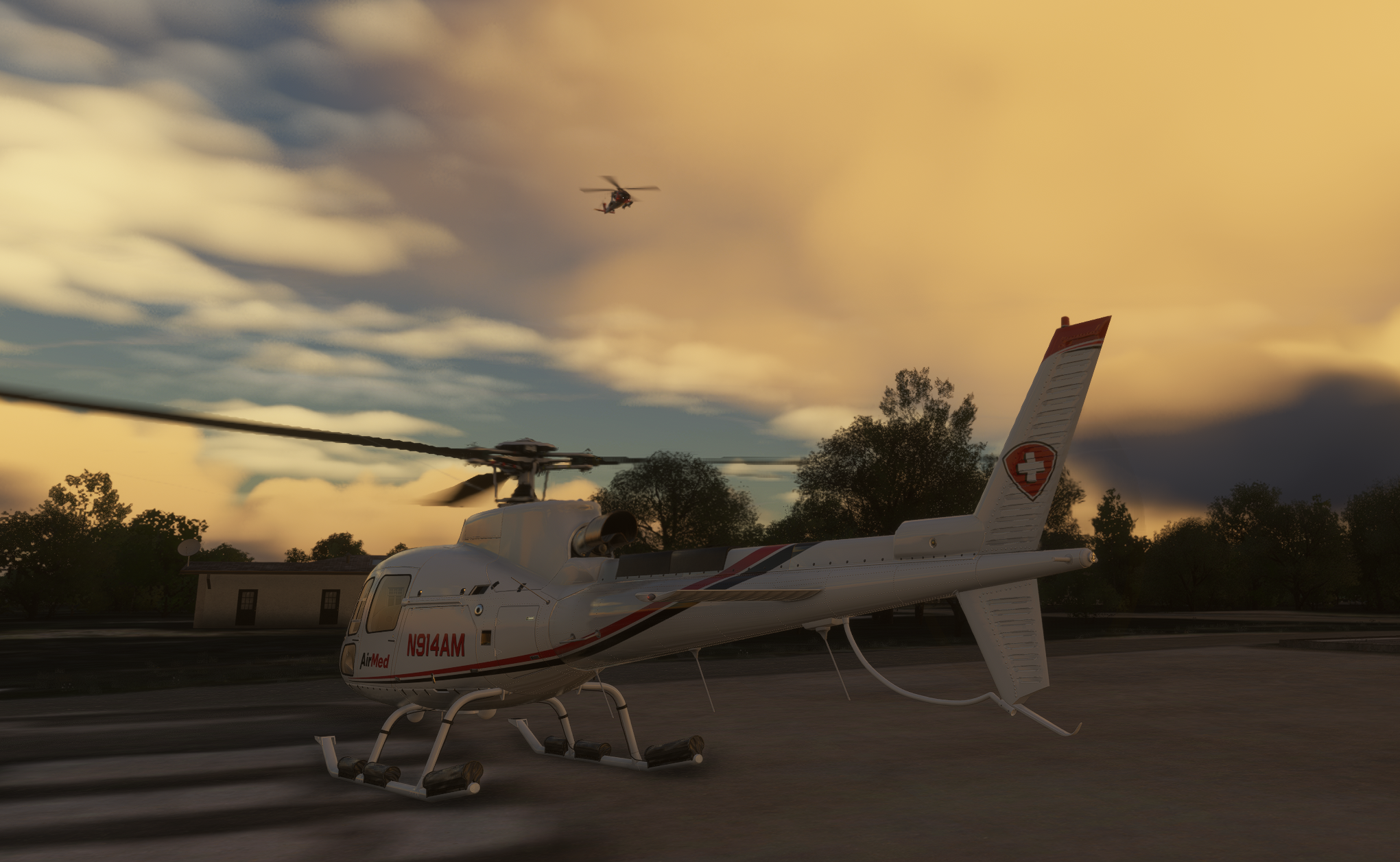 White AirMed medical helicopter (N914AM) on the apron at dusk