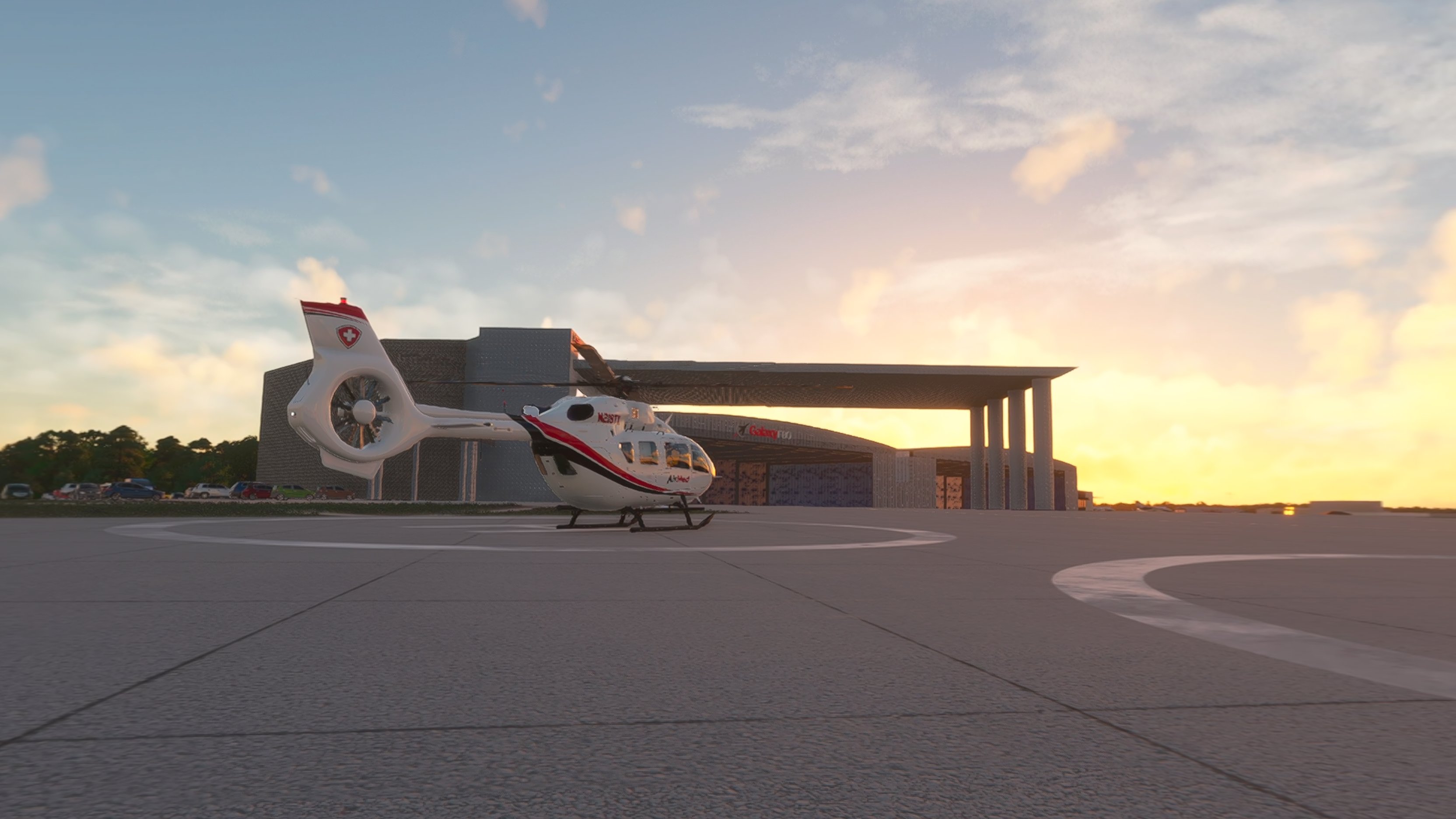 AirMed helicopter (N218TX) on a concrete helipad at sunset