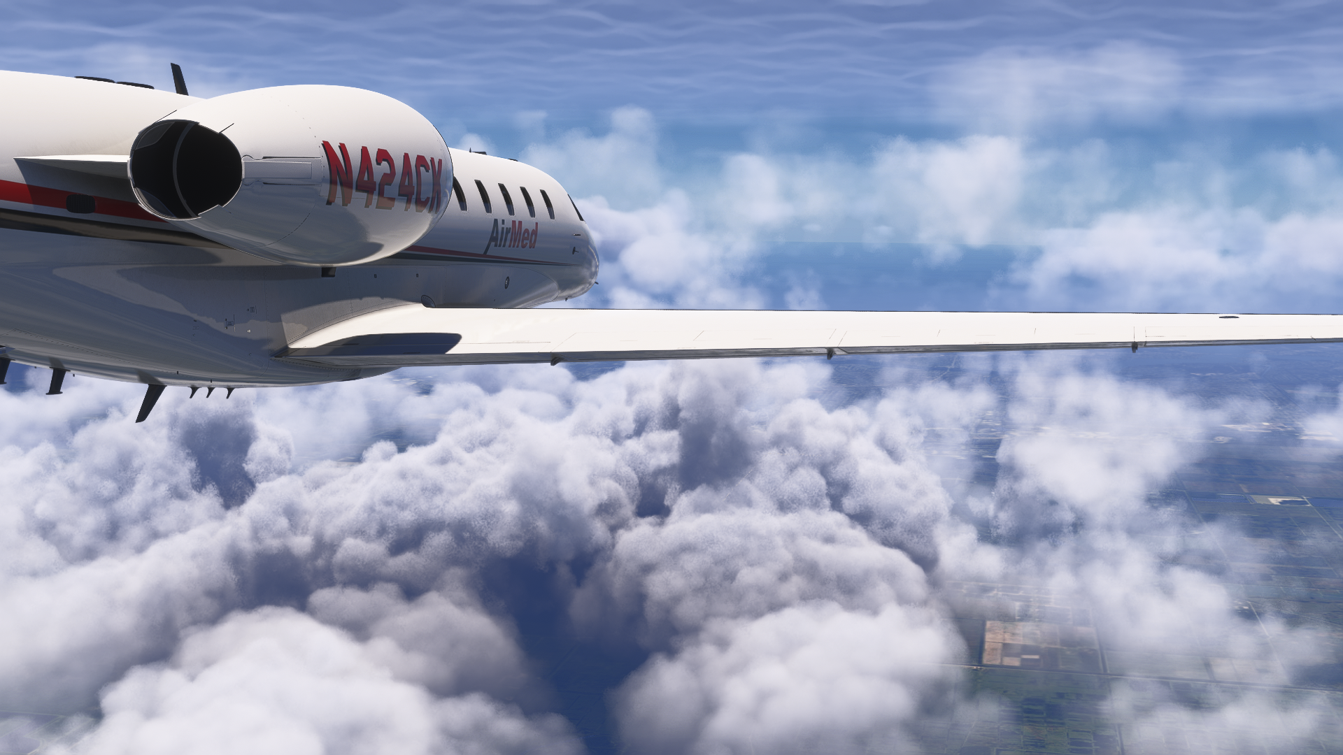 AirMed jet (N424CX) in flight above a layer of cumulus clouds
