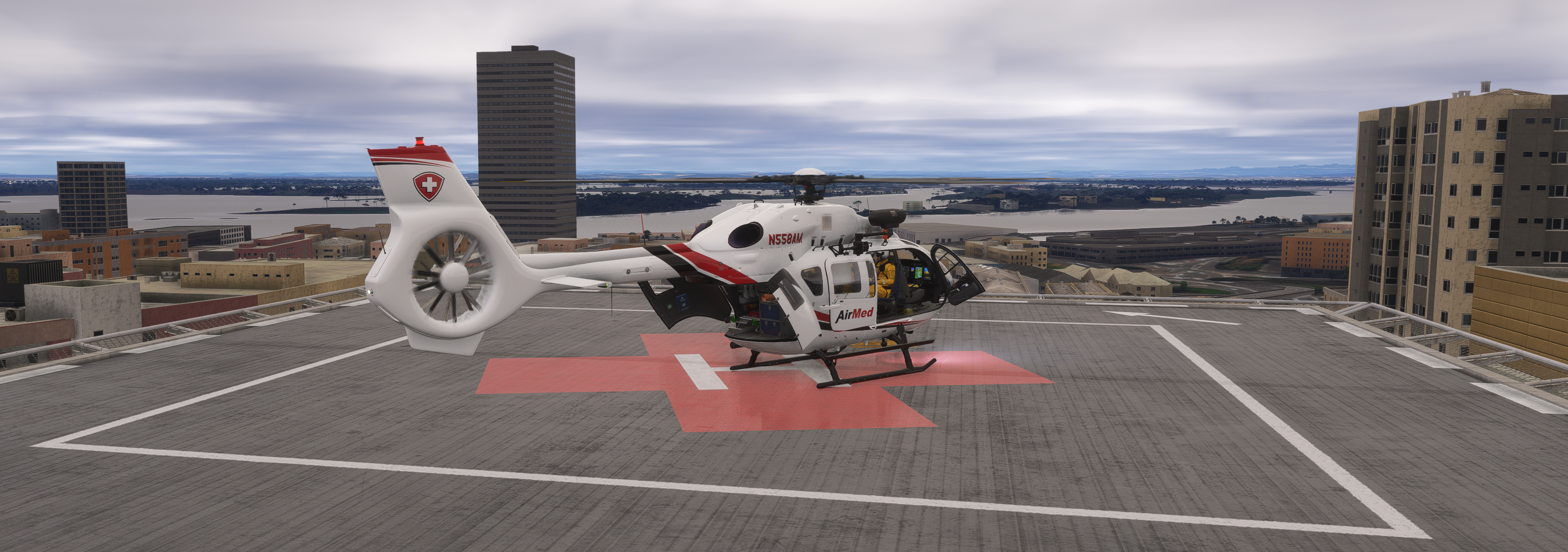 AirMed medical helicopter (N558AM) parked on a rooftop helipad