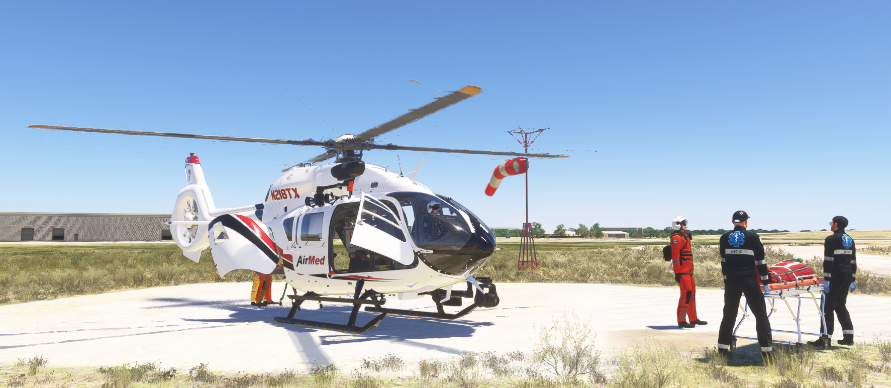 AirMed helicopter (N218TX) on a landing pad with medics loading a stretcher