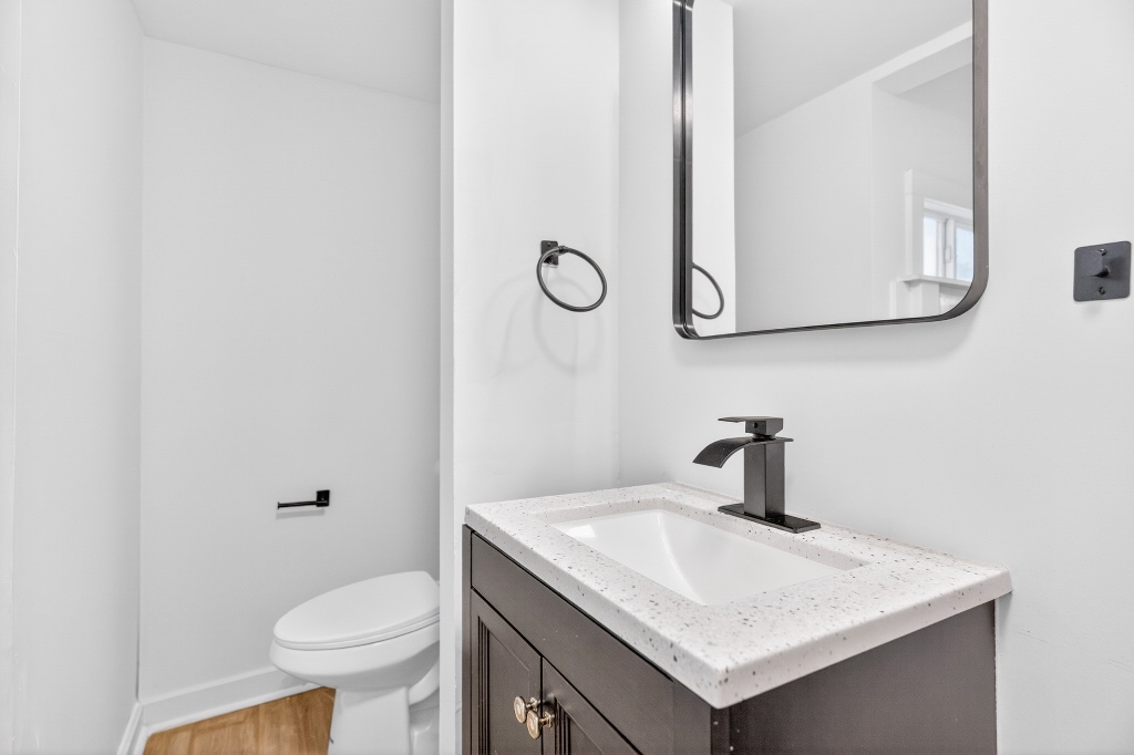 Modern Half-Bath with Dark Vanity and Matte Black Accents