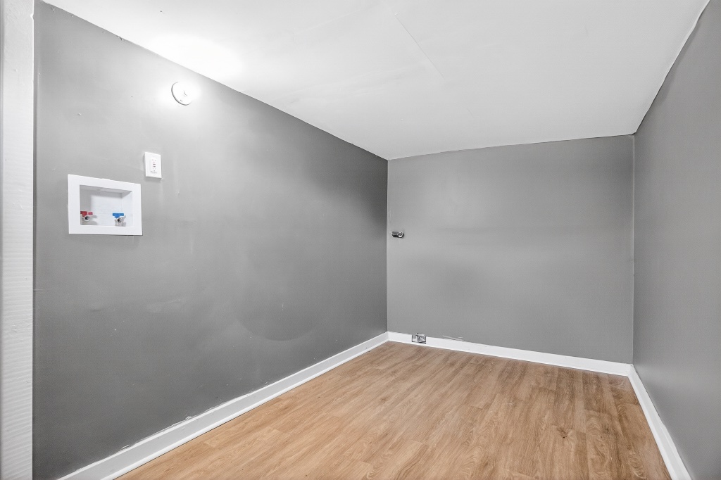 Laundry Room with Dedicated Utility Hookups and Neutral Finishes