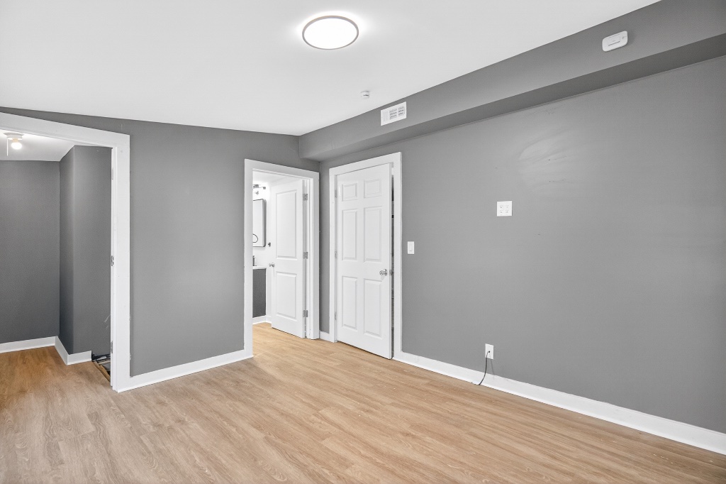 Versatile Room with Updated Laminate Flooring and Neutral Grey Walls