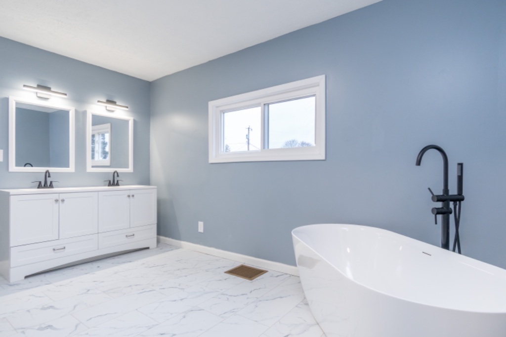 Double Vanity with Freestanding Soaking Tub and Marble Floors