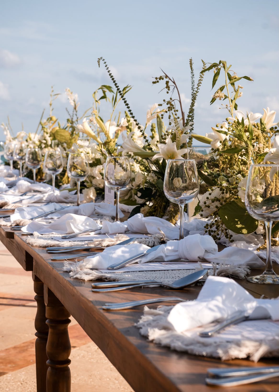 Outdoor banquet table set for an event — tutto events