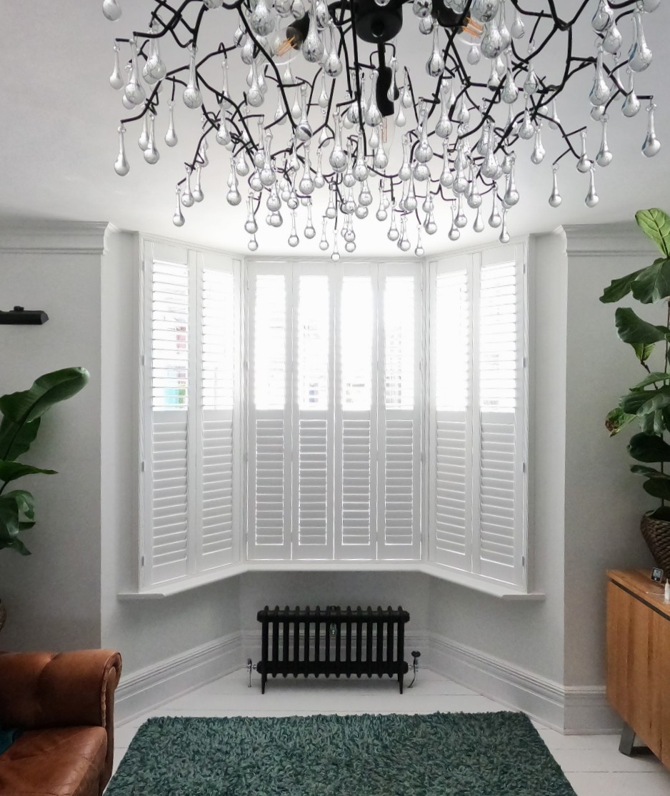 Beautiful plantation shutters in a modern living room with golden hour sunlight