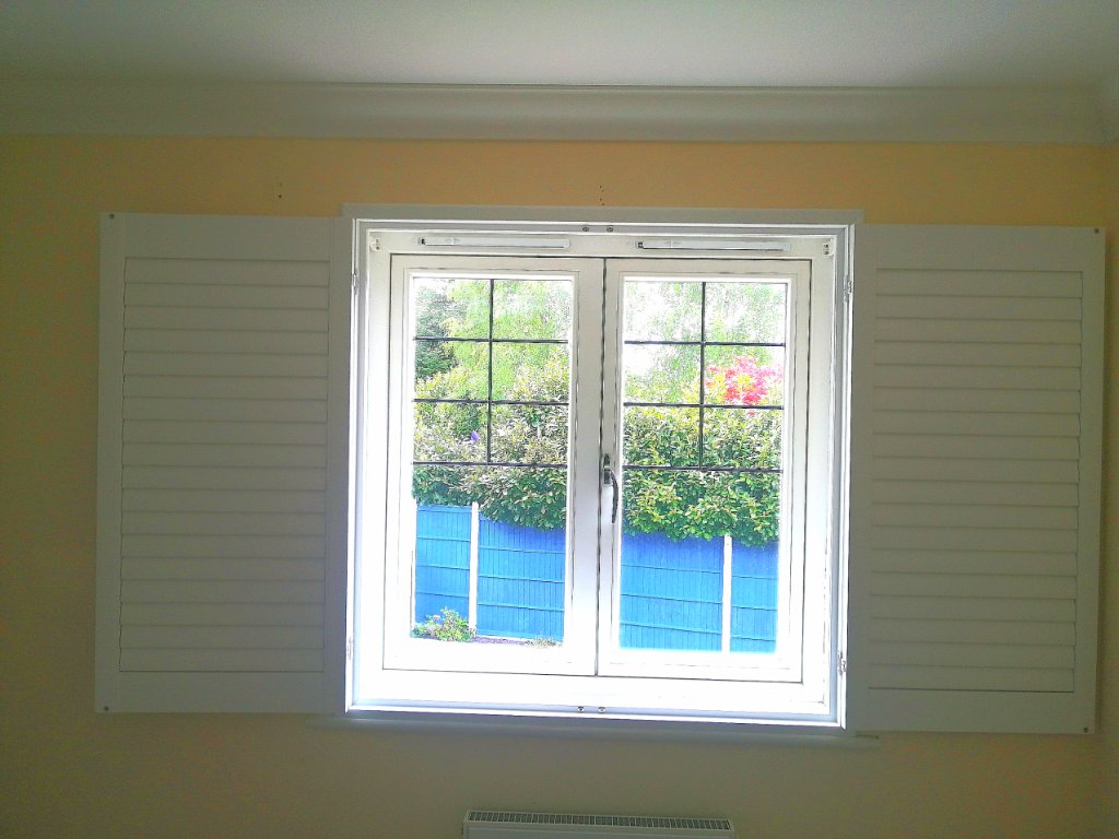 White Plantation Shutters — Multi-Pane Window