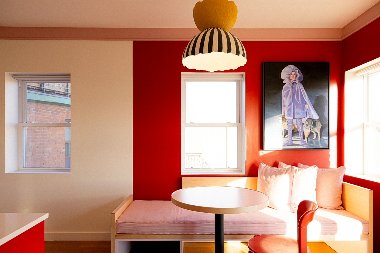 Ode Toronto suite dining nook with red wall and pendant light