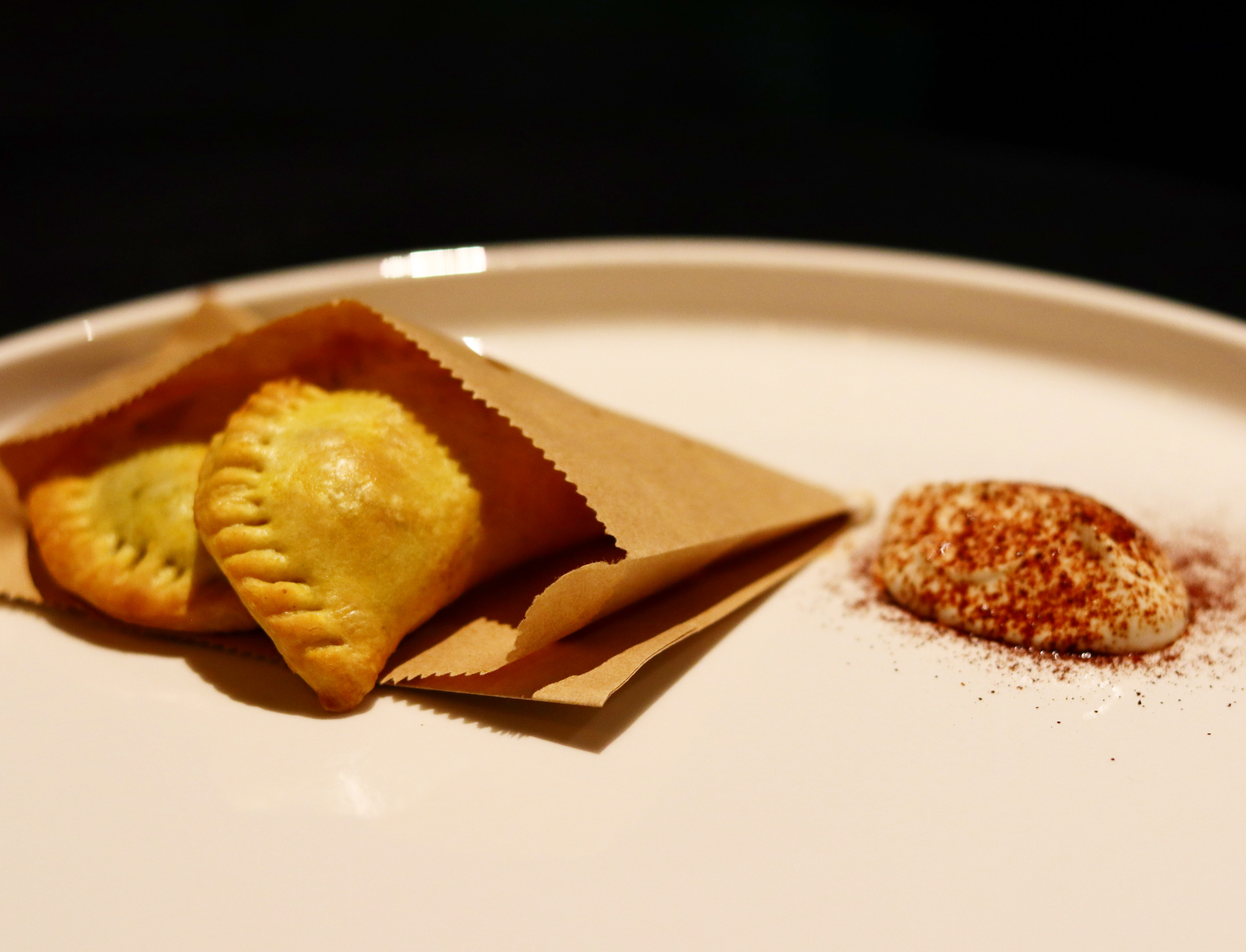 A plated pastry course with a creamy accompaniment