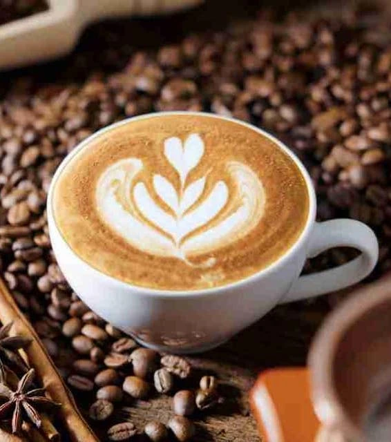 Latte with heart art on coffee beans at Bare Acre Farm