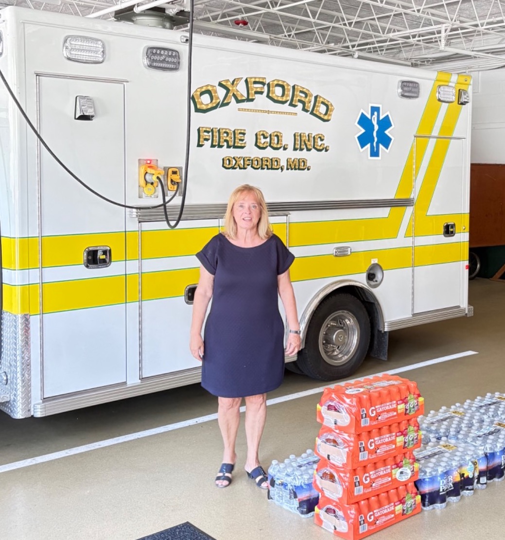 Carol Van Erven in front of an ambulance