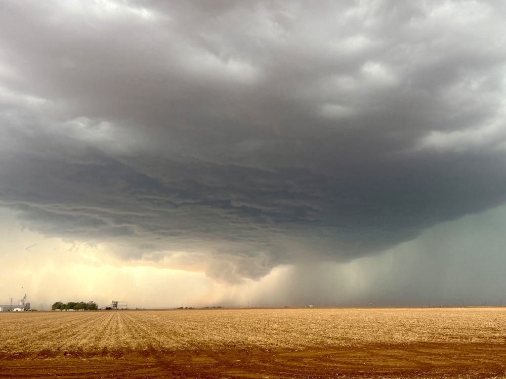 Shelf cloud sweeping over harvested fields