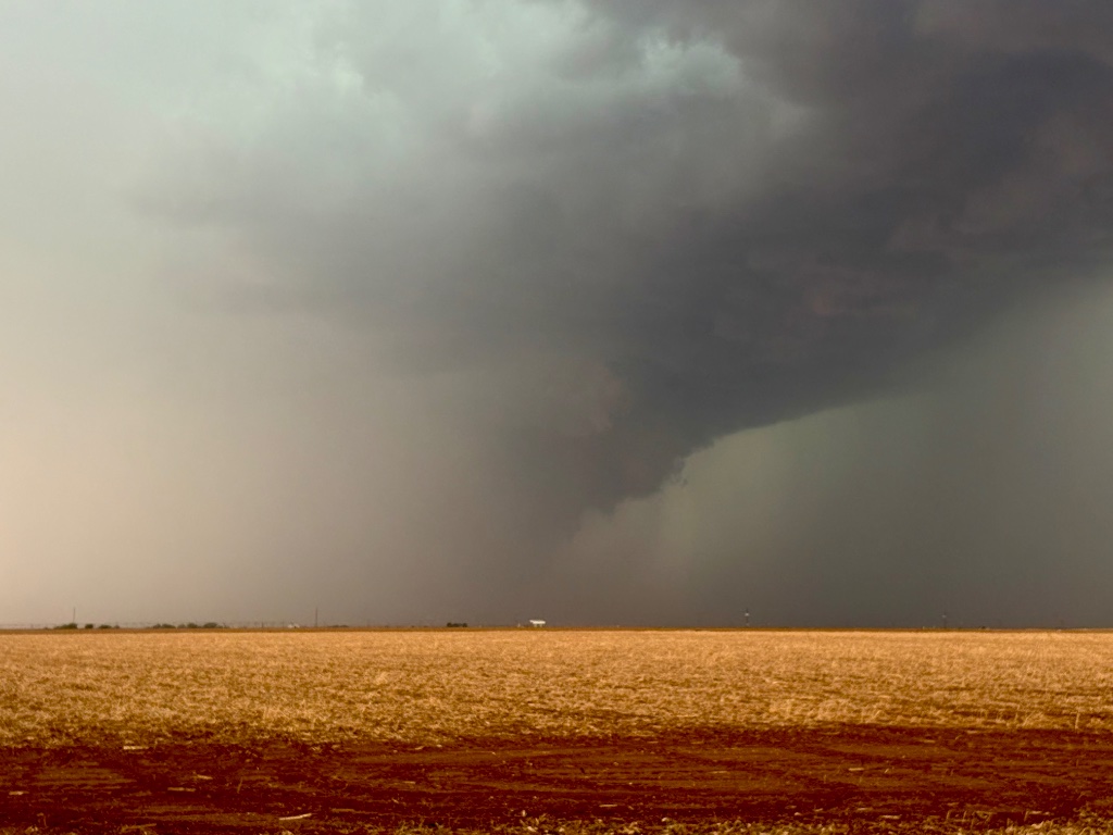 Wall cloud descending over wheat fields