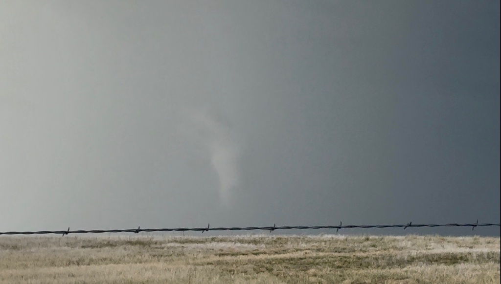 Elephant trunk tornado through barbed wire fence