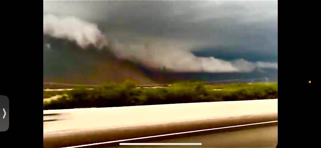 Massive wedge tornado viewed from moving vehicle