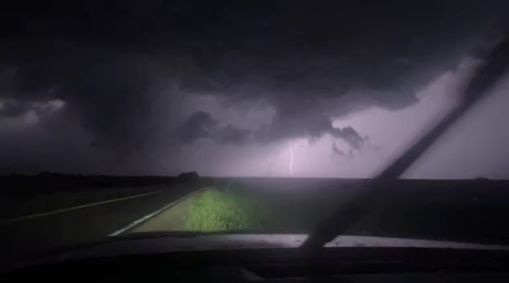 Lightning strike from inside the chase vehicle at night