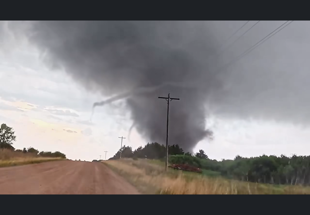 Large wedge tornado crossing a dirt road