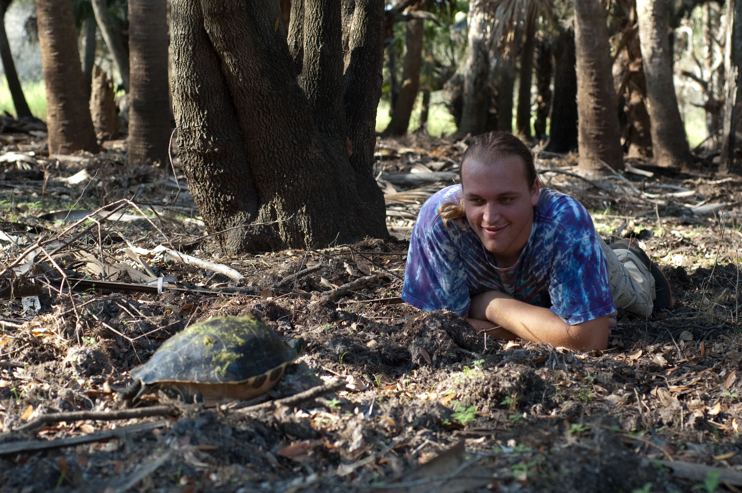 Moses Michelsohn observing a turtle in its forest habitat