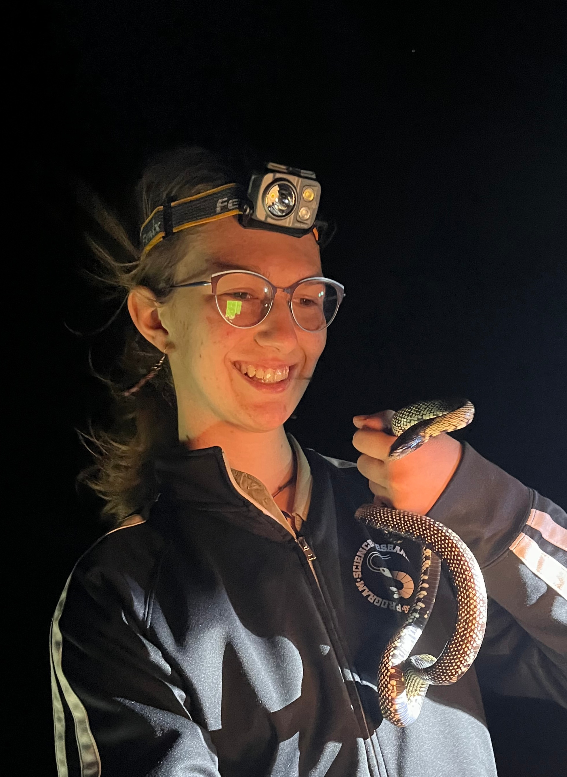 Nika Povelikin, fieldwork with a snake