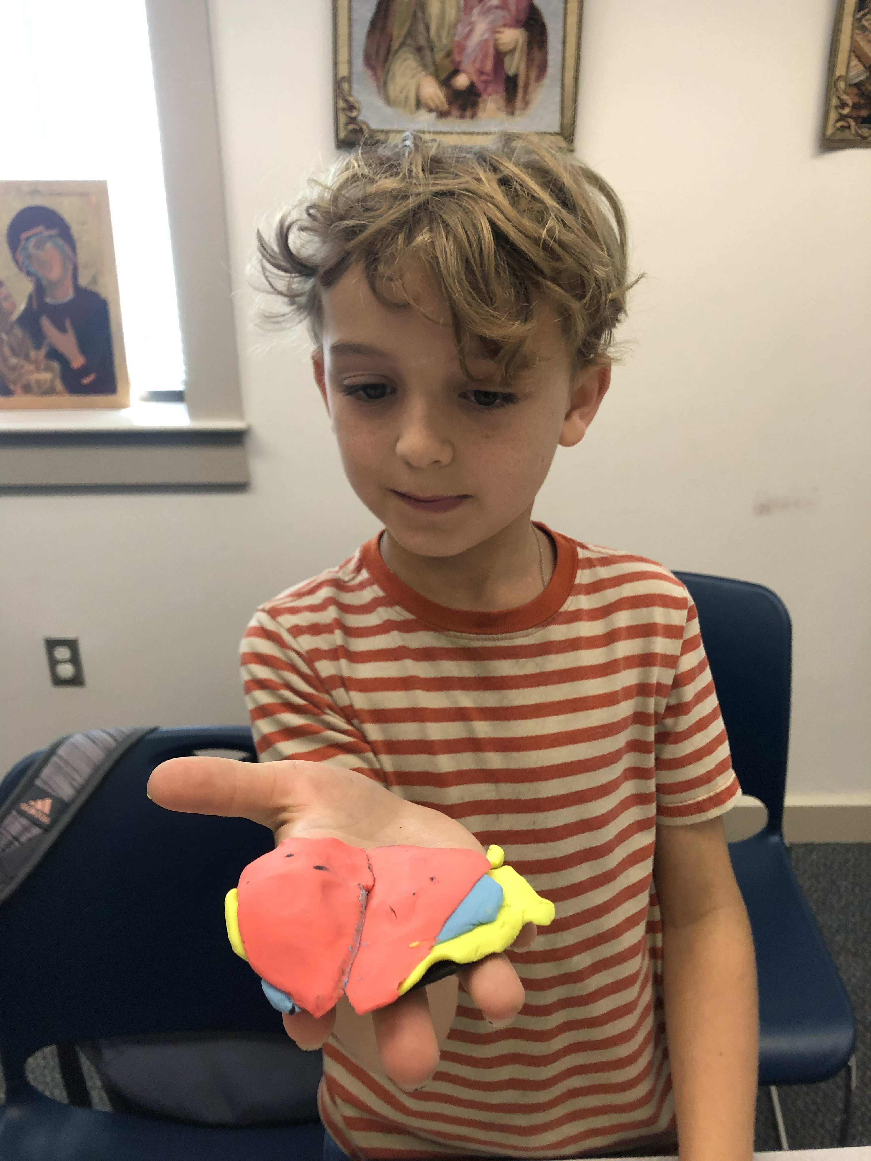 Outreach: A colorful clay sculpture in progress