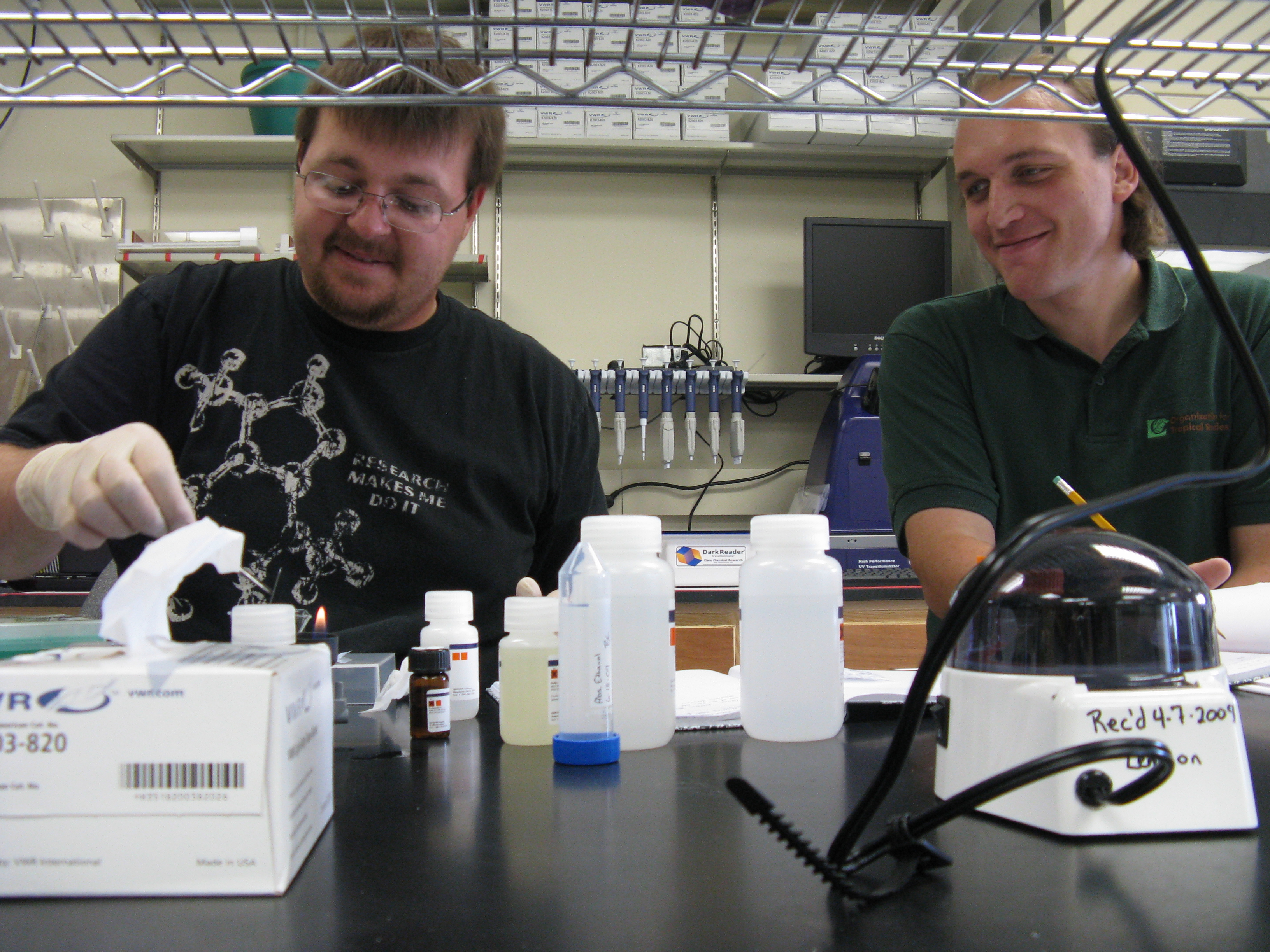 Moses Michelsohn and Brian Caudle working at the lab bench with lab supplies